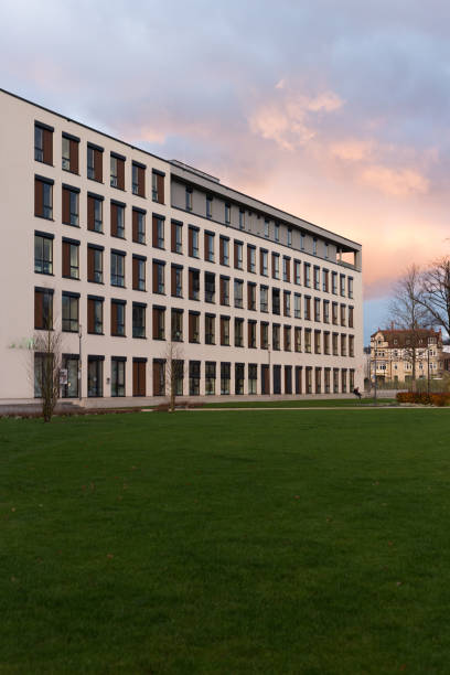 istock office buildings with sunset autumn colored sky and clouds 875127572