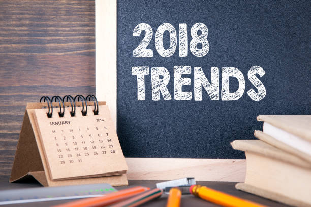 istock 2018 trends. paper calendar and chalkboard on a wooden table 875134076