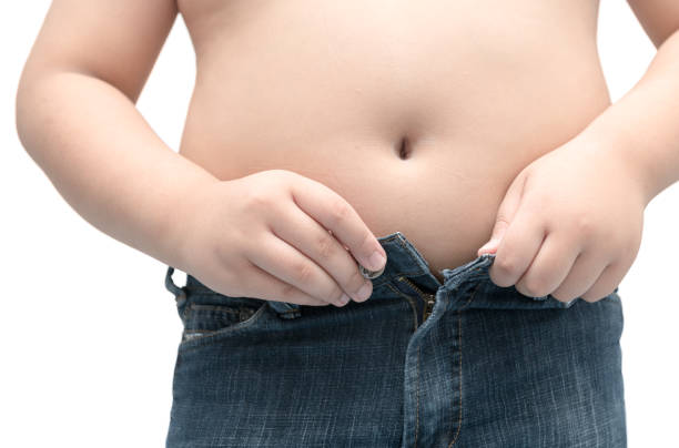 istock Obese fat boy try to wear jeans isolated 875134258