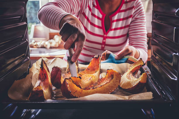 istock Cutting Fresh Pumpkins for Roasting in the Oven 875134354