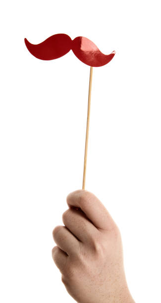 istock Photo booth prop shaped like red mustache held aloft 875134858
