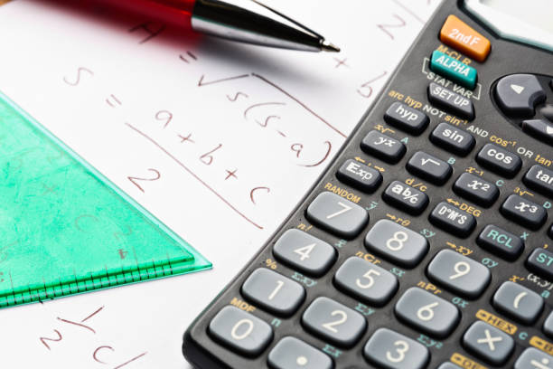 istock Calculator, set square, ballpoint pen and math equation 875137390