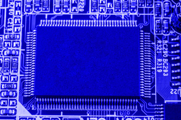 Integrated semiconductor microchip on blue circuit board representative of the high tech industry and computer science.