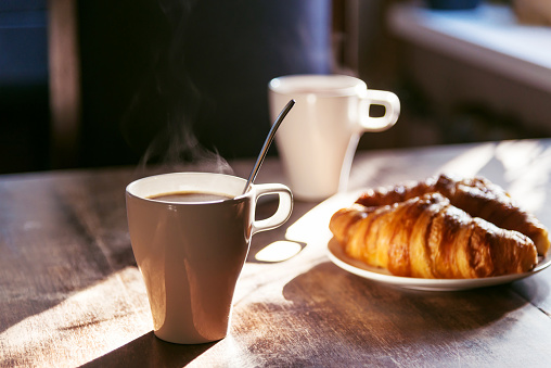 breakfast for two person with cup of hot coffee and fresh croissantsbreakfast for two person with cup of hot coffee and fresh croissants
