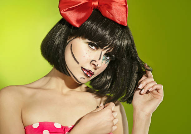 Funny mime girl with a red bow Portrait of funny mime girl with a theatrical makeup and red bow in a polka-dot dress pantomime dame stock pictures, royalty-free photos & images