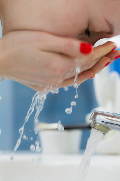 istock Woman washing face in bathroom. Hygiene. 875150608