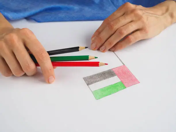 Photo of Lady draws the flag of UAE. UAE National Day celebration decorative item.