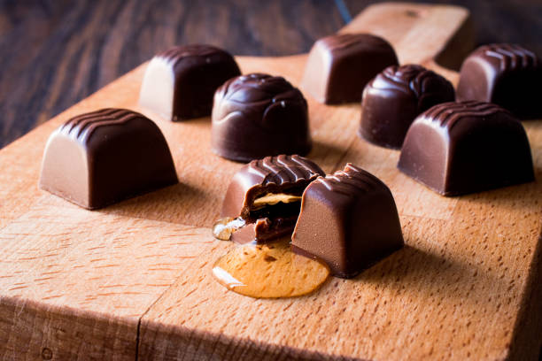 istock Liquor is flowing from the chocolate on wooden surface. 875151118