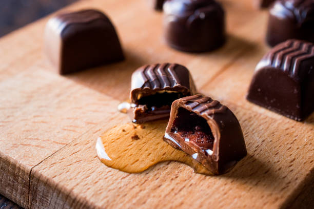 istock Liquor is flowing from the chocolate on wooden surface. 875151124