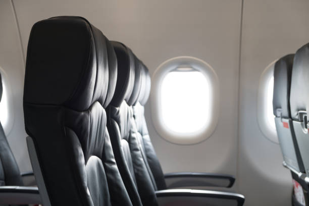 istock Black leather seats in airplane cabin, economy class 875154274