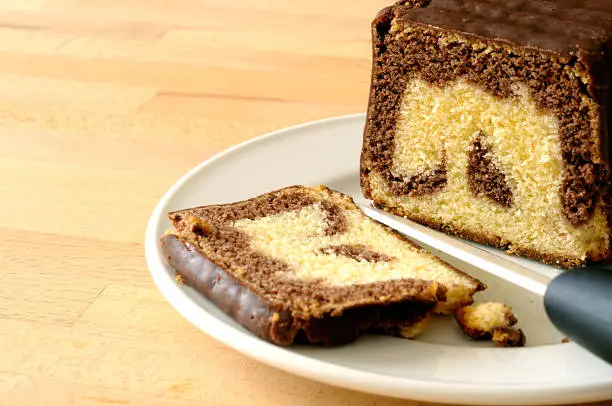 Chocolate marbled plumcake, close up on a kitchen table