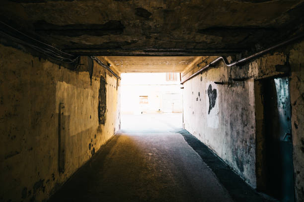 istock Urban dark tunnel or corridor with bright light in the end 875161436