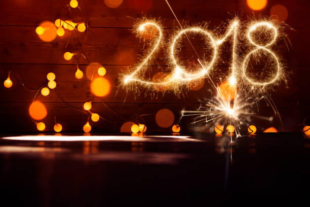 istock Sparkler New Year 2018 With Fireworks On Wooden Floor 875161444