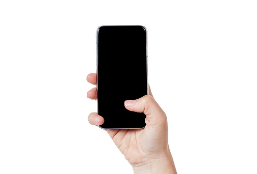 A woman's hands hold up a mobile phone, tapping on the touch screen with her thumb.