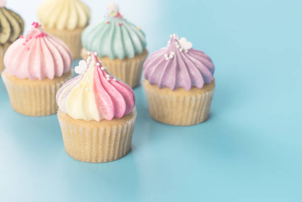 istock Colorful rainbow cupcake set on blue pastel color toning 875164866