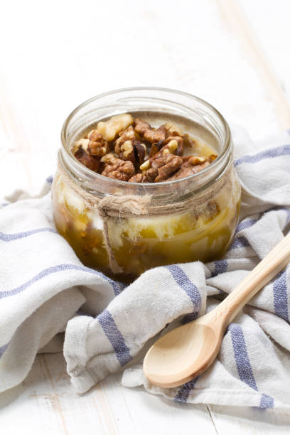 istock Altai candied honey with walnuts in a glass jar 875165110