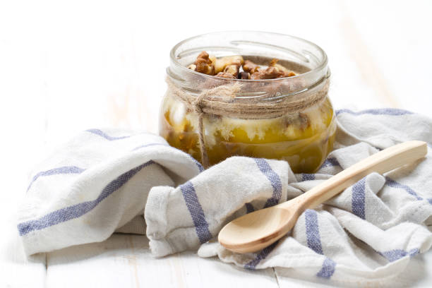 istock Altai candied honey with walnuts in a glass jar 875165178