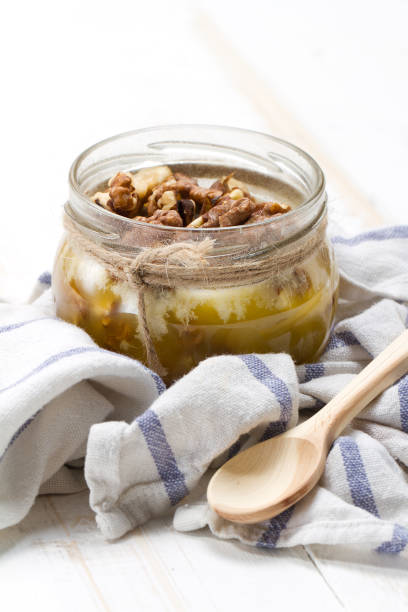 istock Altai candied honey with walnuts in a glass jar 875165310