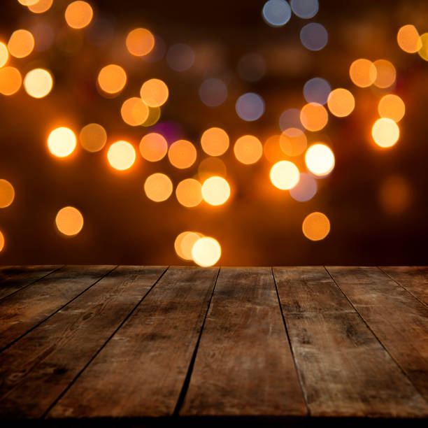 istock Defocused lights behind wooden table 875168654