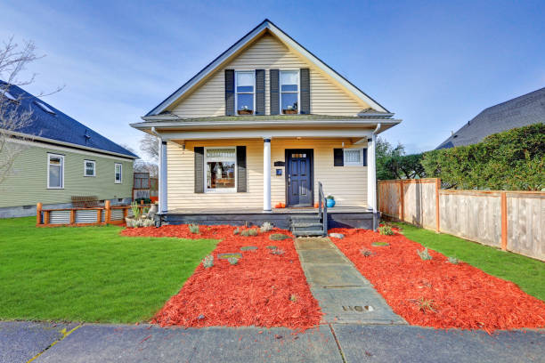 istock Sweet yellow Victorian home features original leaded glass windows 875169742
