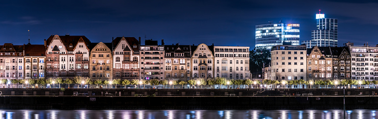 View over the Rhine with typical german old-fashioned architecture and shining city lights. High resolution