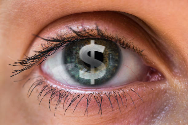Woman eye with dollar or money symbol inside stock photo