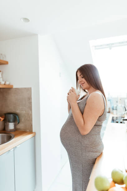 istock pregnant woman resting in the kitchen 875179290