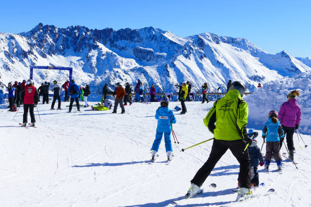 Skiing with teacher Bansko, Bulgaria - January 30, 2016: Ski resort view, skiers on lift, people skiing on slopes. slopestyle stock pictures, royalty-free photos & images