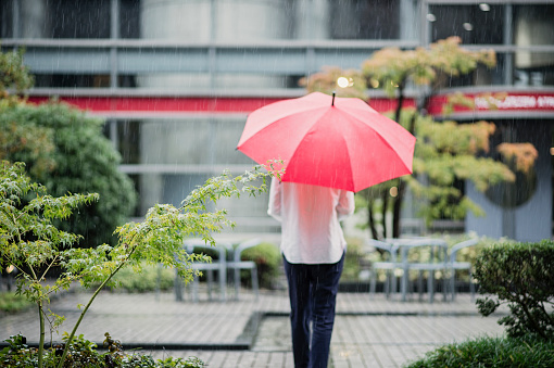 Japanese young adult woman enjoying rainy day