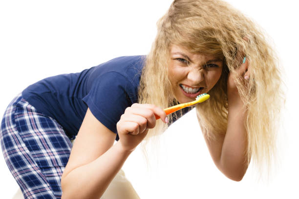 istock Happy woman brushing her teeth 875182452