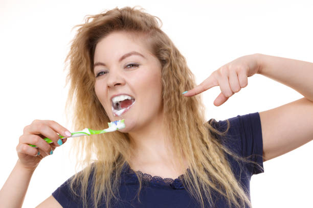 istock Woman brushing cleaning teeth 875186084