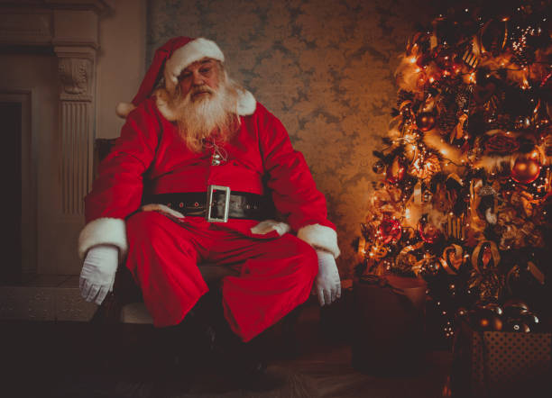 istock Santa tired asleep near Christmas tree 875186346