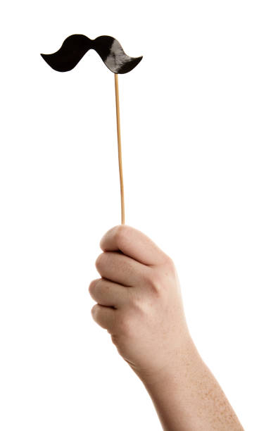 istock Photo booth prop shaped like handlebar mustache is held aloft 875186576
