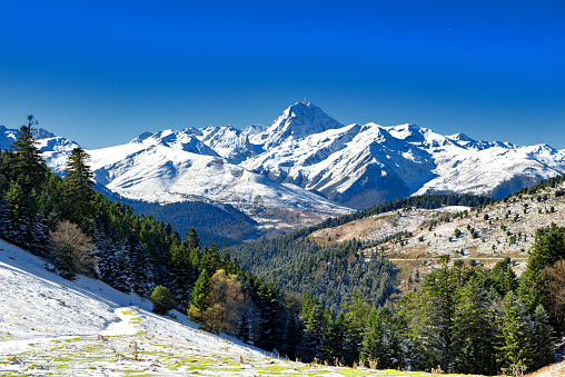 Snow covered mountain landscape in the French Savoie Alps region in the Val Thorens ski area resort during a beautiful clear winter day..