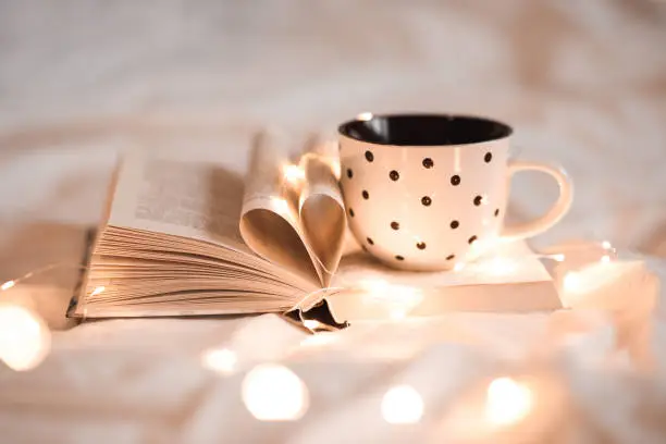 Photo of Cup of tea on open book