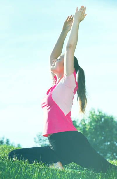 istock Woman in pink T-shirt is practicing stretching 875195304