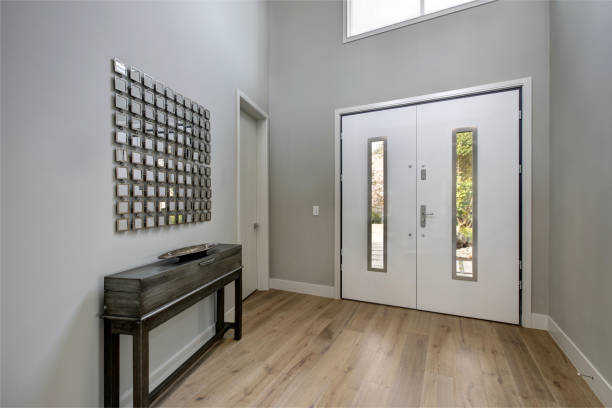 istock White front door opens to a contemporary foyer 875195590