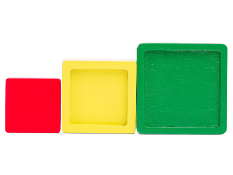 Different squares in size and color stand in a row for the development of a child on a white isolated background