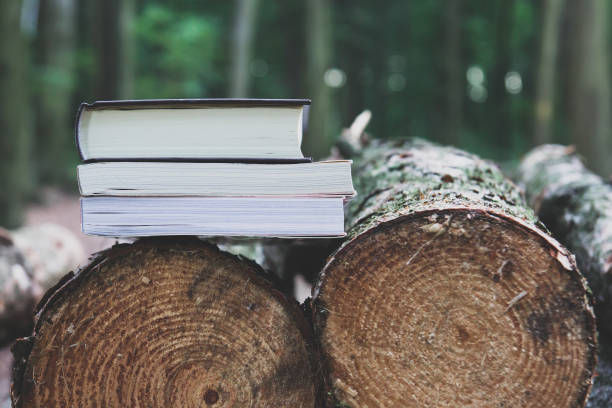 istock A stack of books lying on felled trees,  save trees - read ebooks concept 875199220