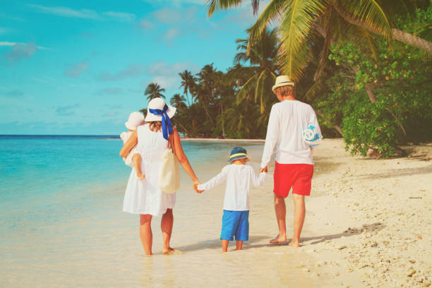 istock happy family with kids walk on beach 875202072