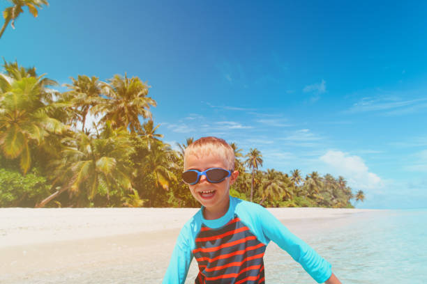 istock little boy play have fun on tropical beach 875206636