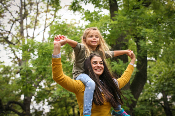 istock Mother carrying her child on shoulder. On the move. 875206802