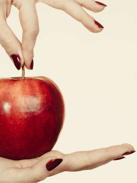 istock Woman hand holding delicious red apple 875209944