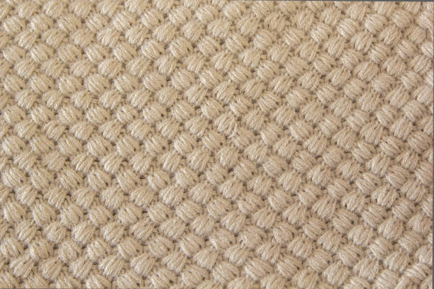 istock Gray knitting wool texture background. knitted fabric texture. Knitted jersey background with a relief pattern. Braids in knitting 875210742
