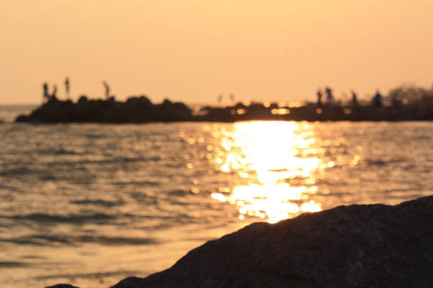 istock Sunset on the sea, people in the background 875213926