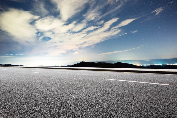 istock empty rural asphalt road by green hill 875222032
