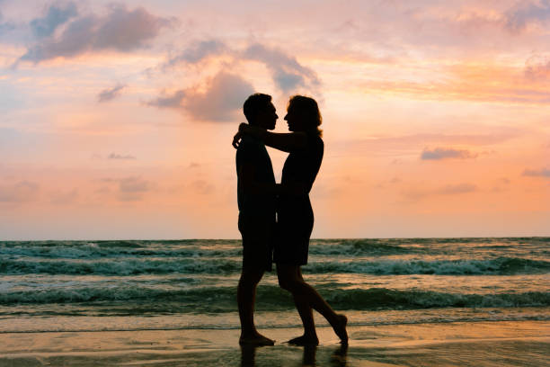 istock Romantic couple on sea sunset beach 875228490
