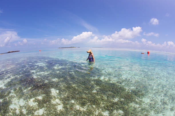 istock Senior woman enjoys time in a clear lagoon 875233630