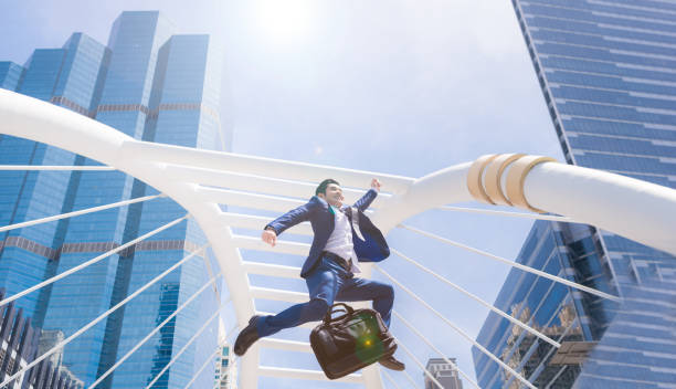 istock Successful businessman jumping 875234060