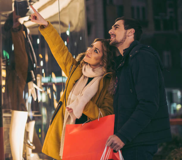 istock Couple looking at clothes in the shop 875237452